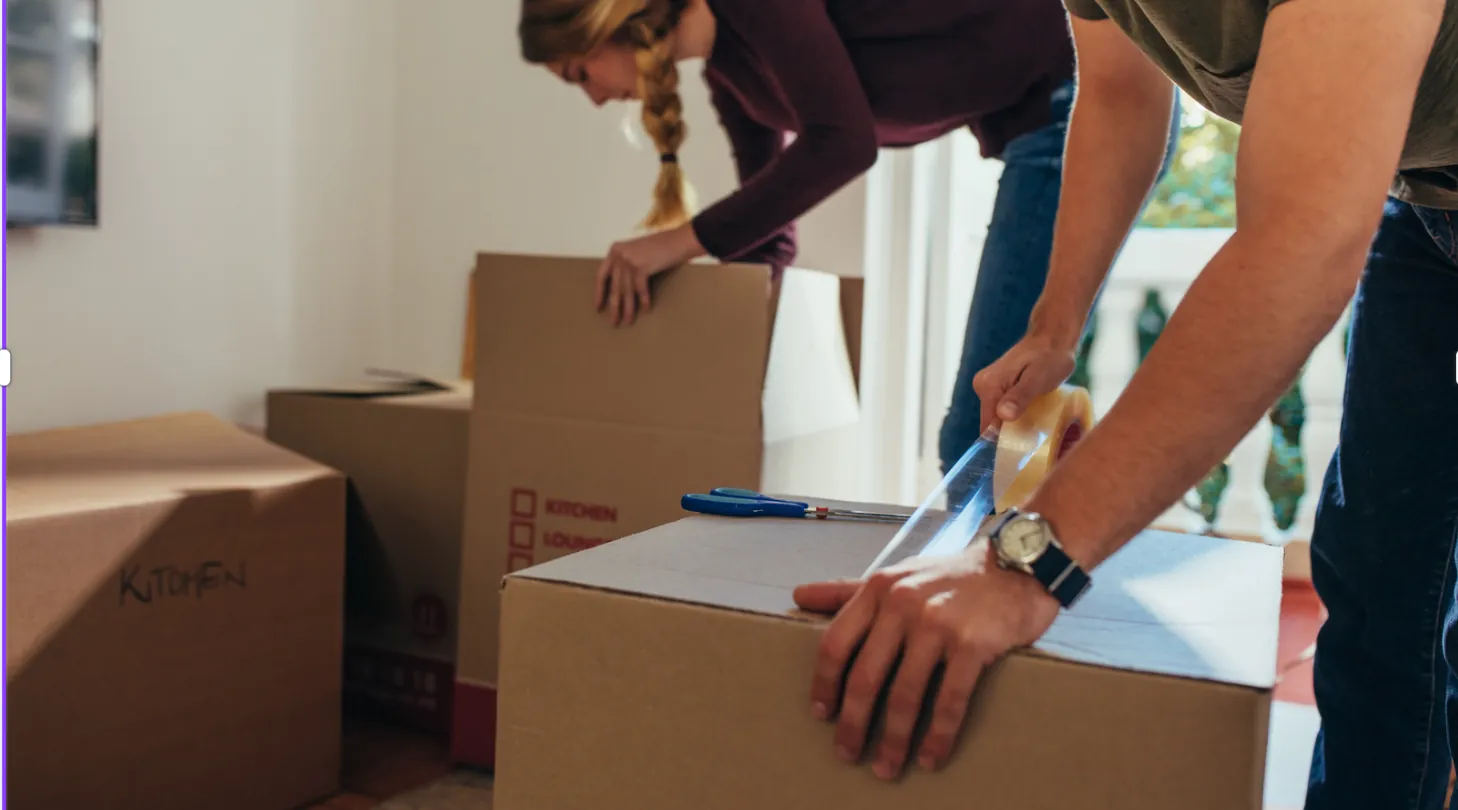 Packing a cardboard box with tape