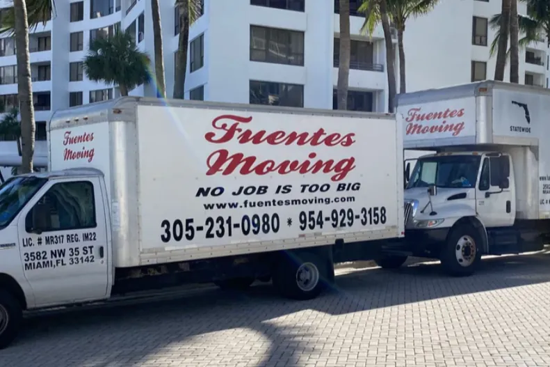 Two Fuentes Moving box trucks with company name, phone numbers and license lettering