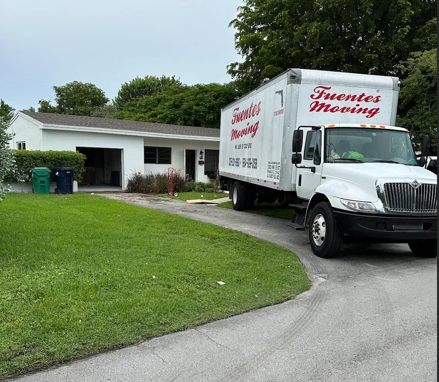 Fuentes Moving truck parked in front of a house for a residential move